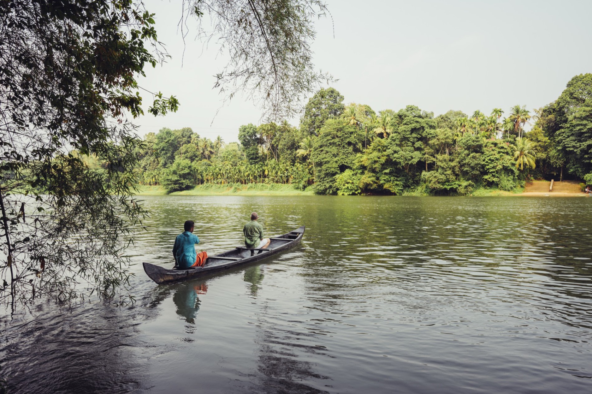 A wooden canoe gliding along the backwaters