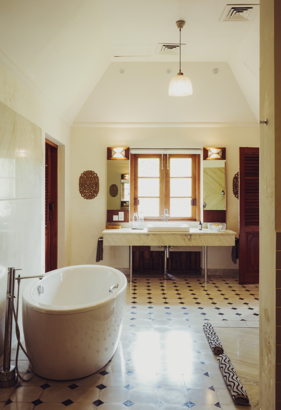 A freestanding bathtub in a light-filled bathroom