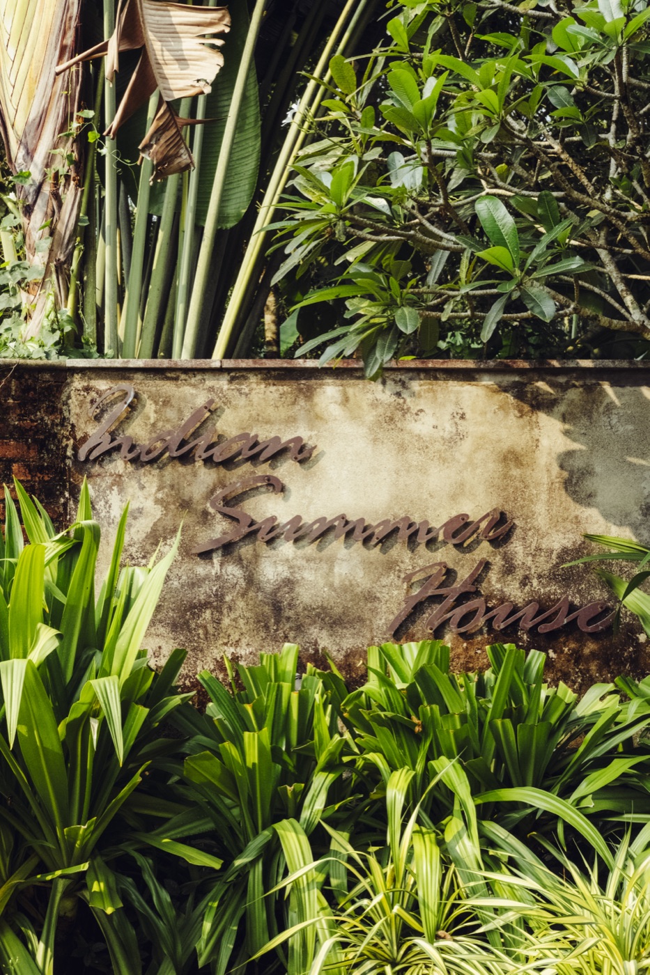 The Indian Summer House sign in the garden