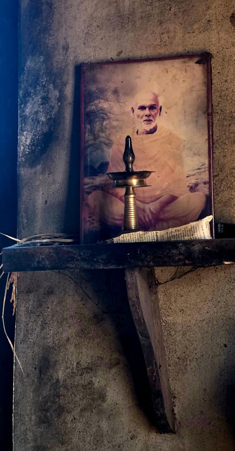 An ancient palm-leaf Sanskrit manuscript and portrait of Swami Neelakantha Theerthapada