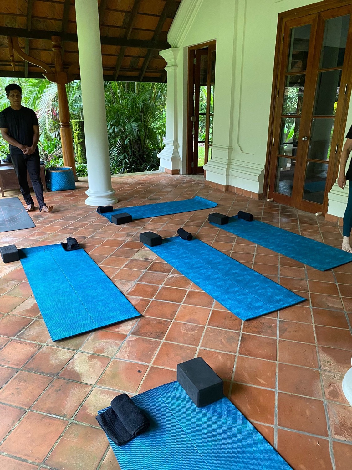 Yoga mats laid out on the veranda for a morning class
