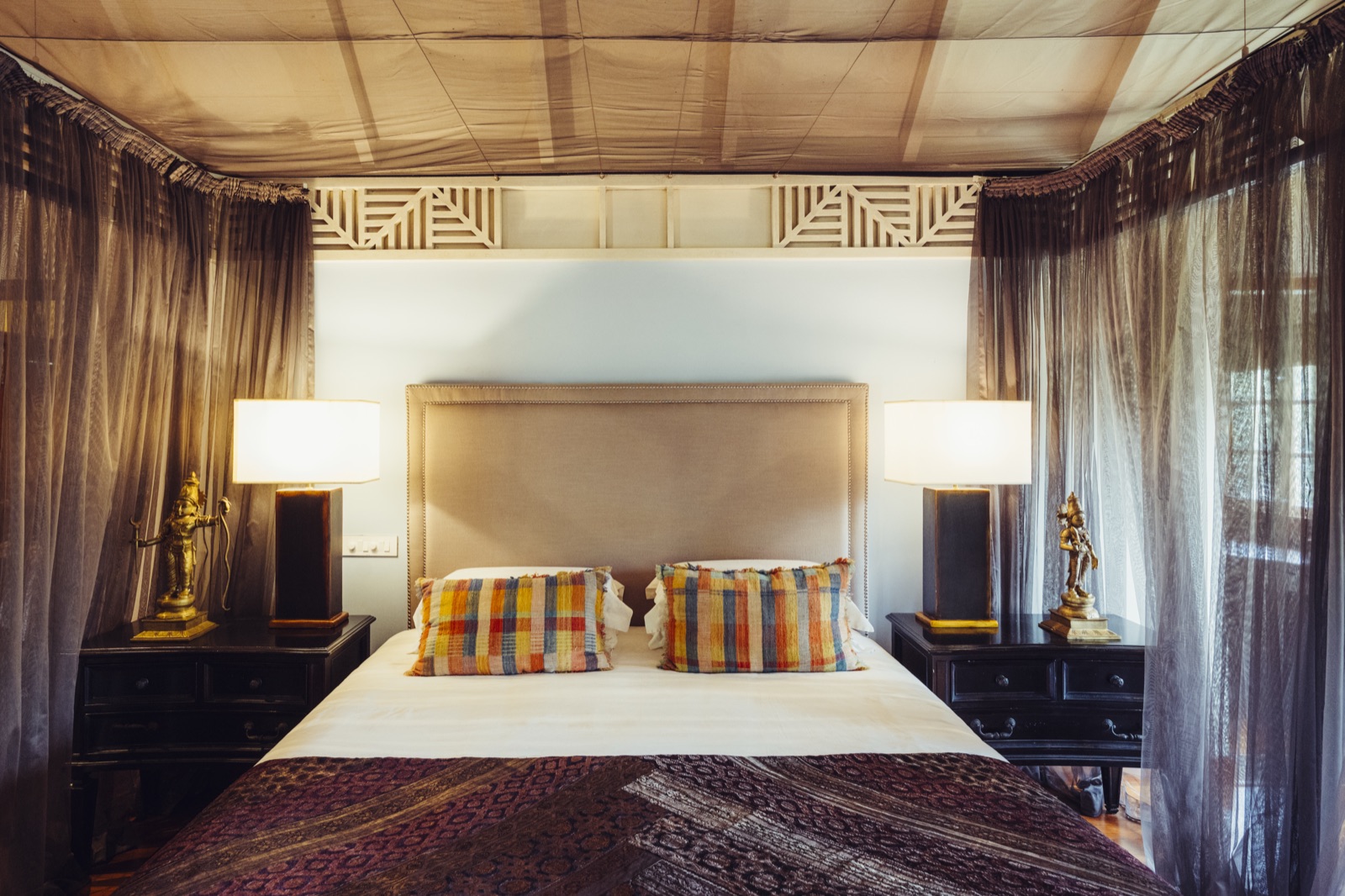 The Sita Suite bed framed by sheer drapes