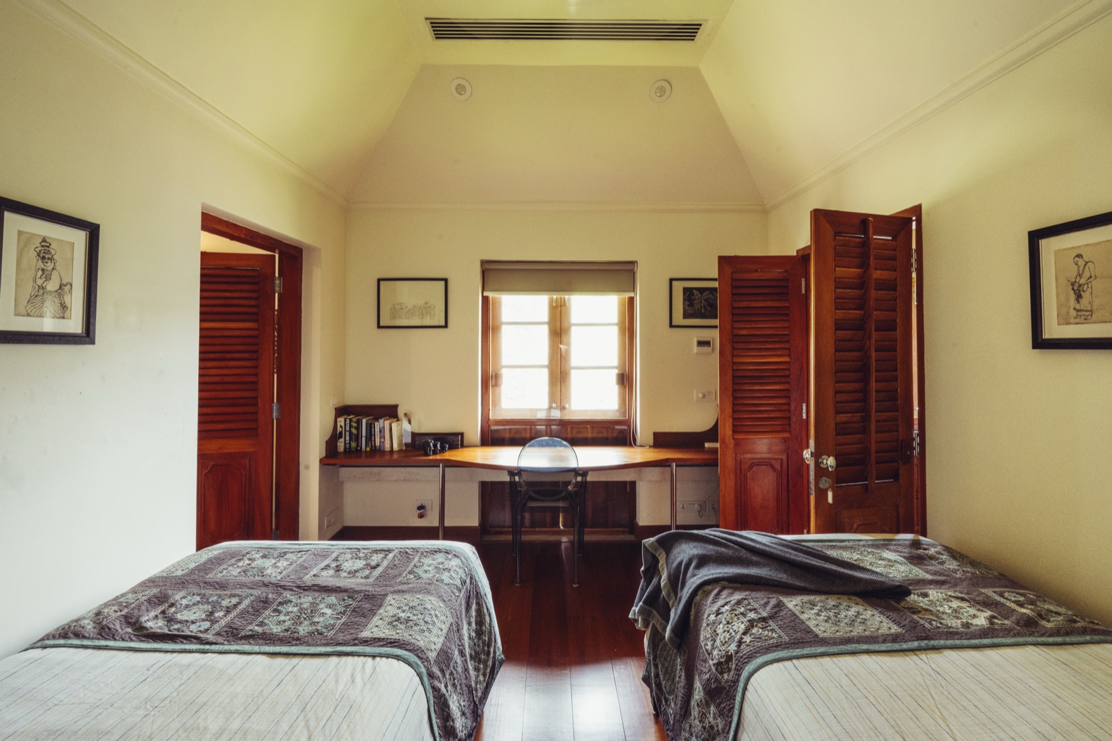 The Sita Suite's second bedroom, with two single beds and a desk