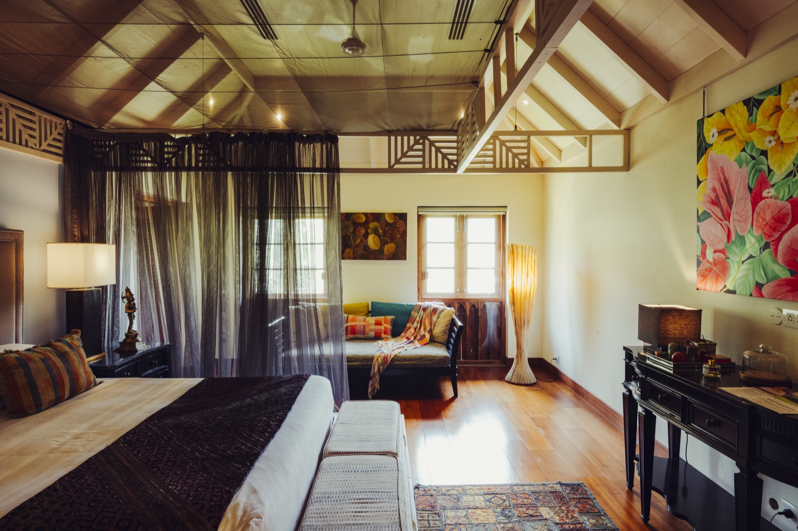 The Sita Suite at Indian Summer House, a canopy bed under a high timber roof