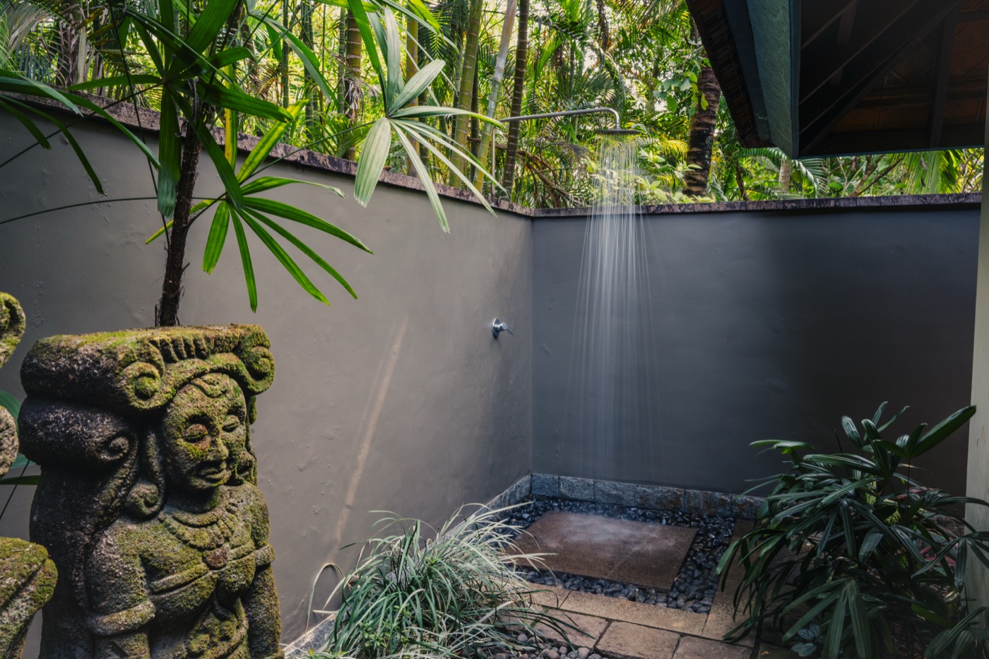 Stone shower court with carved guardian