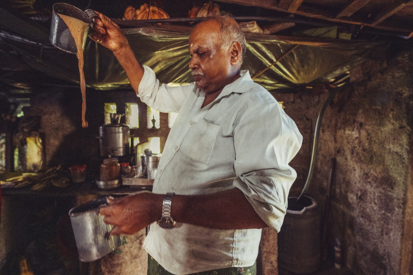 The village tea house, tea poured in a long stream