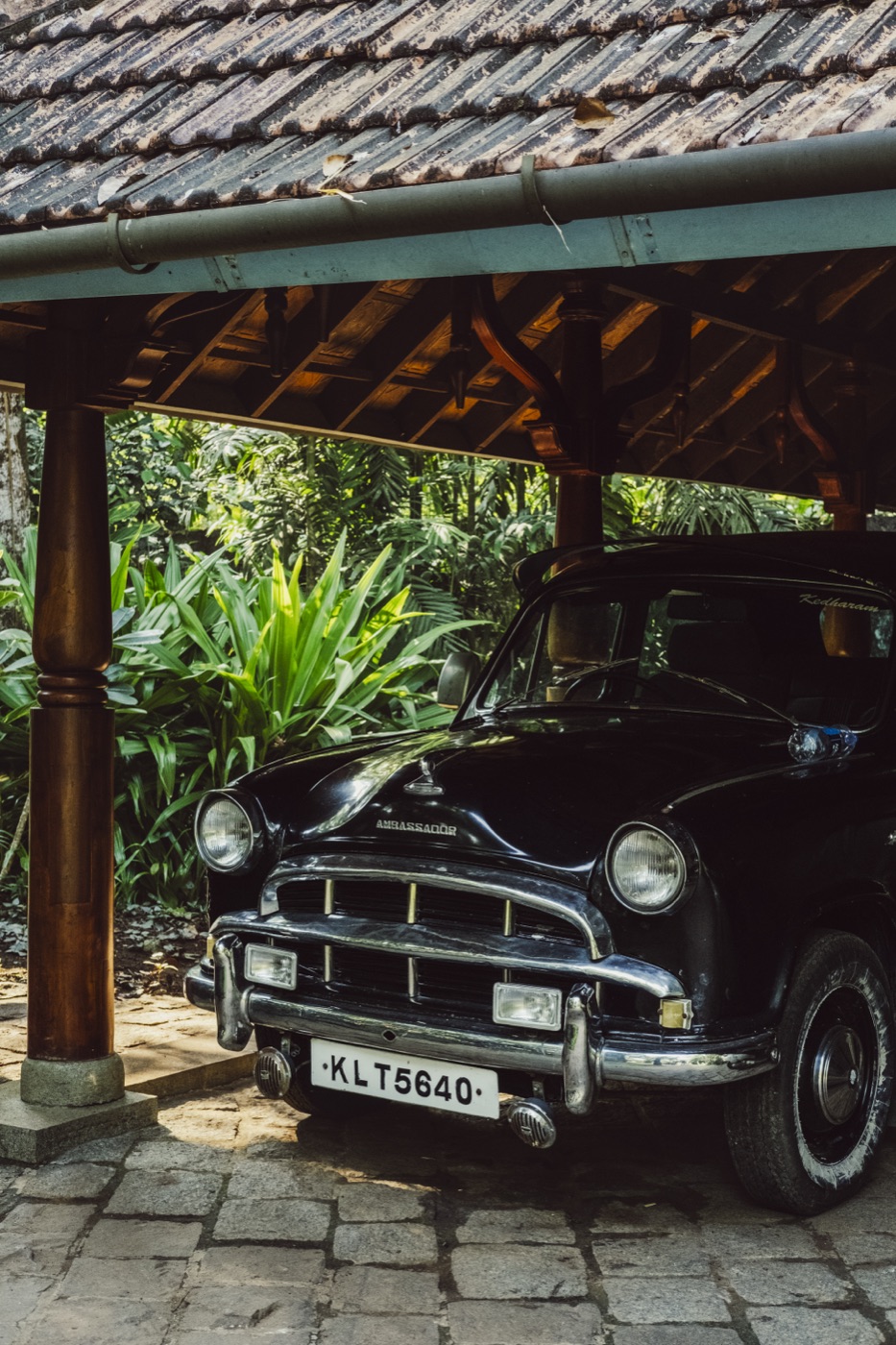 The estate's vintage car under the portico