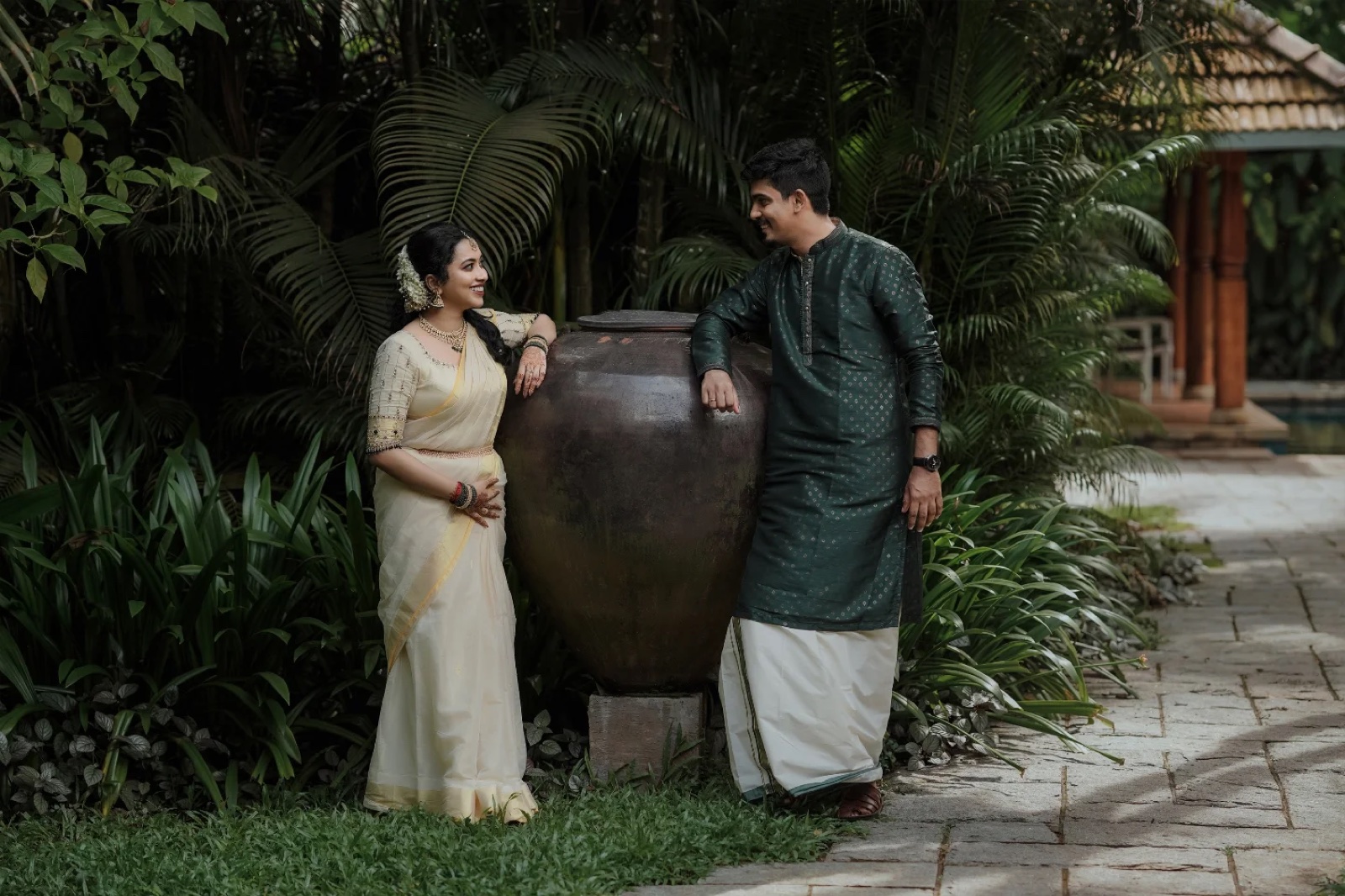 A couple beside the garden's great urn