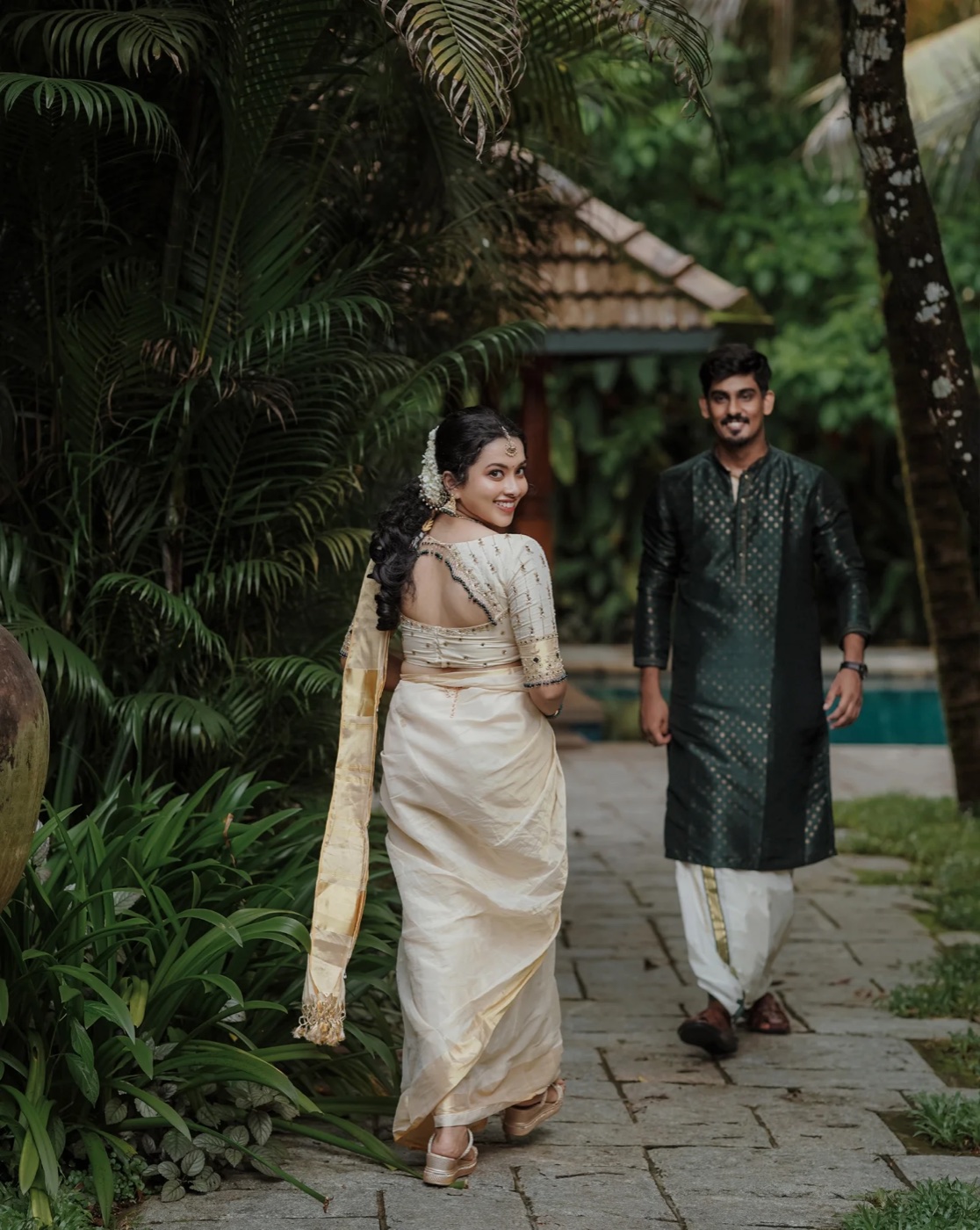 A couple on the garden path by the pool